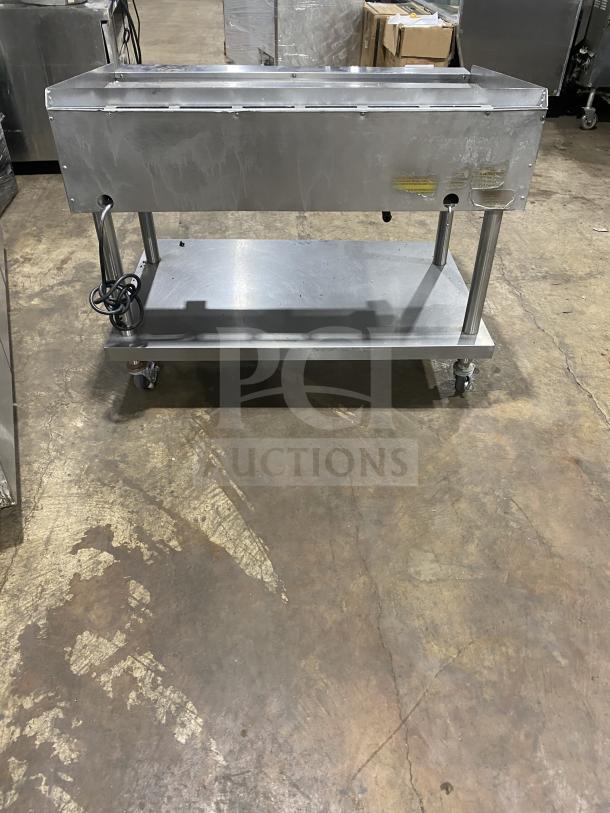 Vulcan stainless steel countertop flat griddle with backsplash and undershelf cart on casters. Natural gas, 120V, 1 phase.