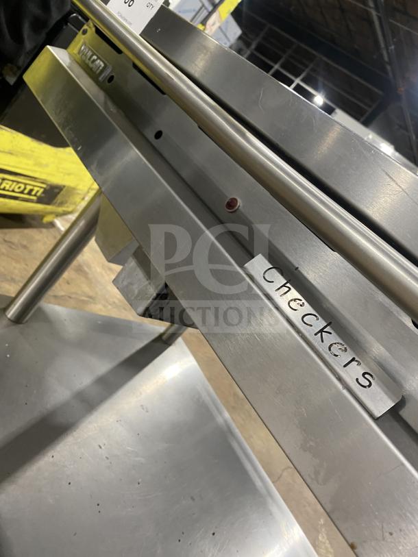 Vulcan Checkers Style commercial stainless steel flat griddle, natural gas, with back and side splash, on casters.