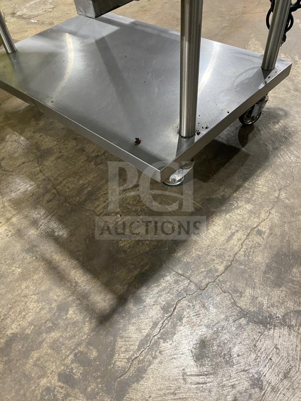Vulcan stainless steel griddle stand with castors, featuring a single undershelf and side splashes. Appears in good condition.