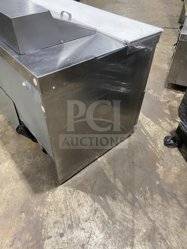 Delfield UCD4464N-12-DD5 stainless steel 4-drawer sandwich prep table, 115V, in good condition with minor surface wear.