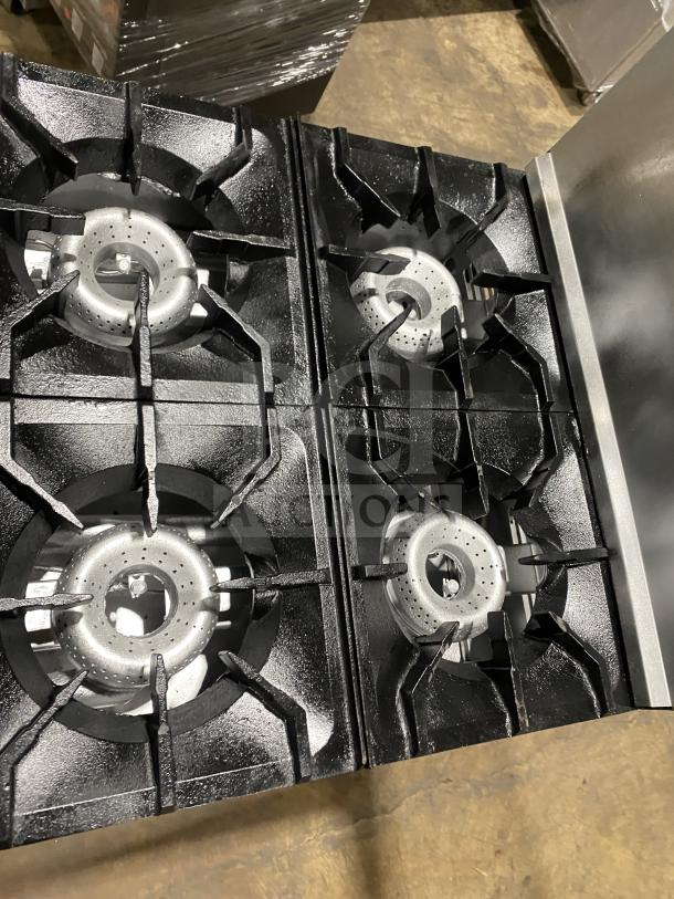 American Range commercial stainless steel gas 4-burner range/oven with backsplash, salamander shelf, and casters.