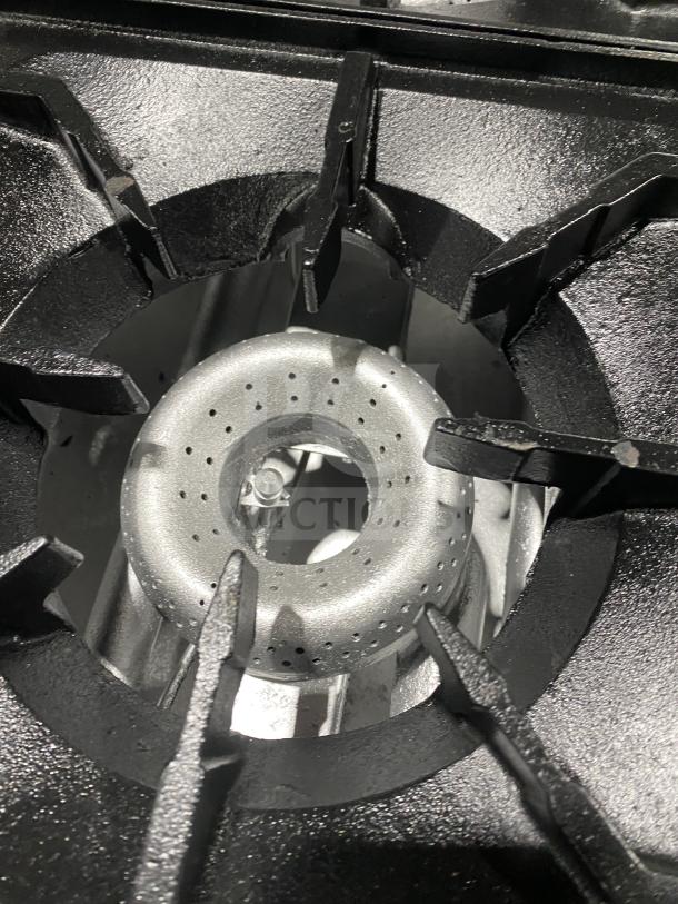 American Range stainless steel gas powered 4-burner range/oven combo, features overhead salamander shelf, in excellent condition.