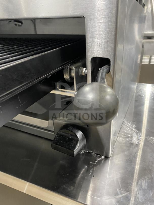American Range stainless steel salamander broiler, commercial-grade, details on control handle and grilling surface shown.