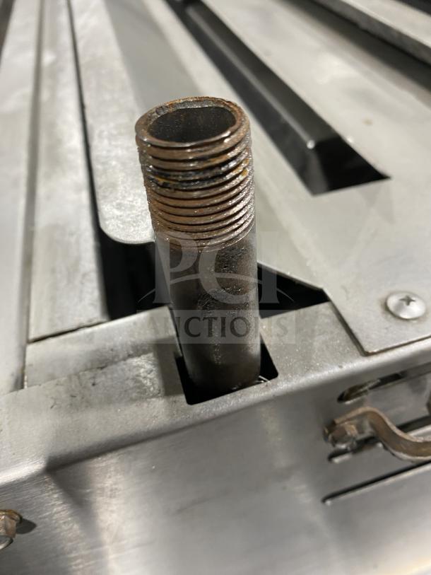 American Range stainless steel salamander broiler, commercial model. Visible wear and rust on fittings. Ideal for professional kitchens.