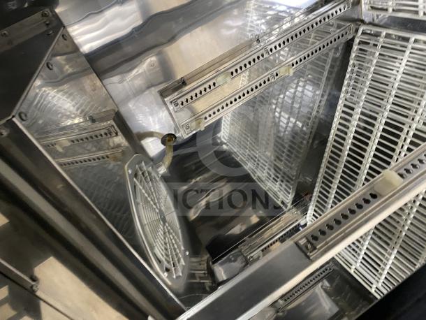 Commercial back bar black refrigerator with poly coated wired rack, two sliding glass doors in excellent condition.