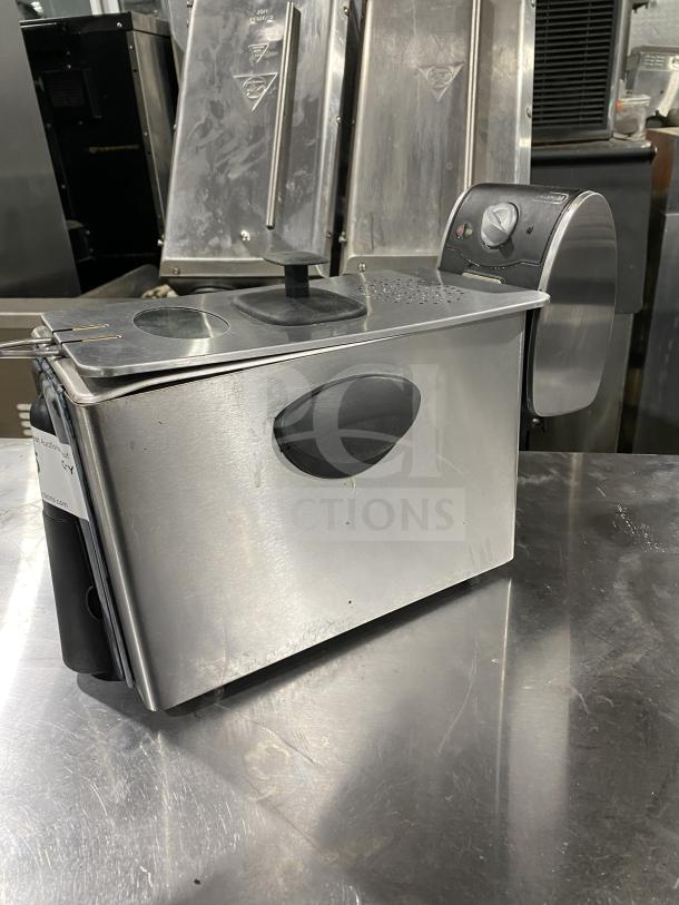Stainless steel commercial food warmer, used condition, with visible controls and vented lid, on a metal countertop.