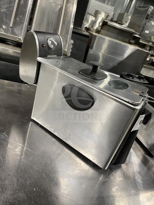 Stainless steel deep fryer with dial control and indicator lights, in good condition, featuring a sleek design.