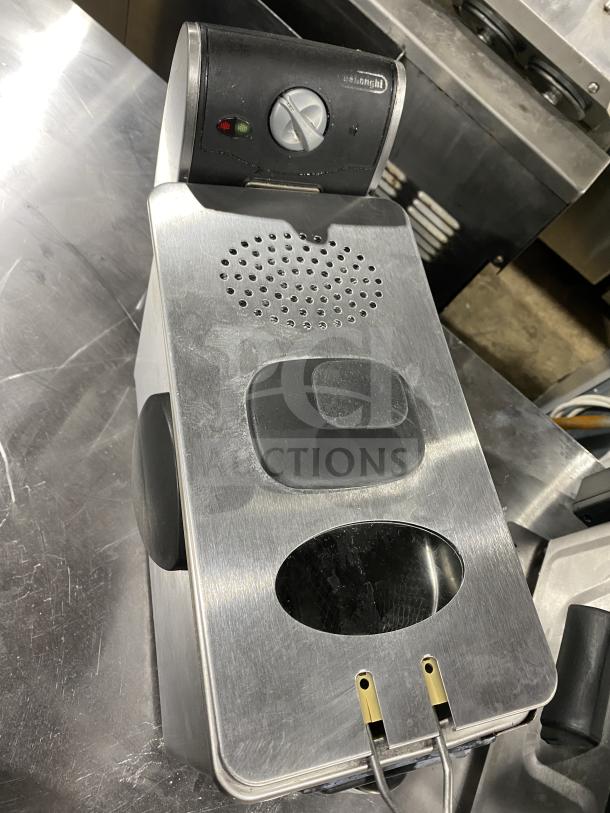 DeLonghi espresso machine, stainless steel and black finish, dial controls, light indicators, in good condition.