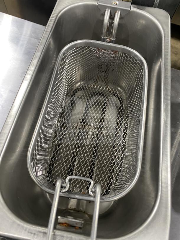 Stainless steel deep fryer with mesh basket, durable design, clean condition, suitable for commercial kitchen use.