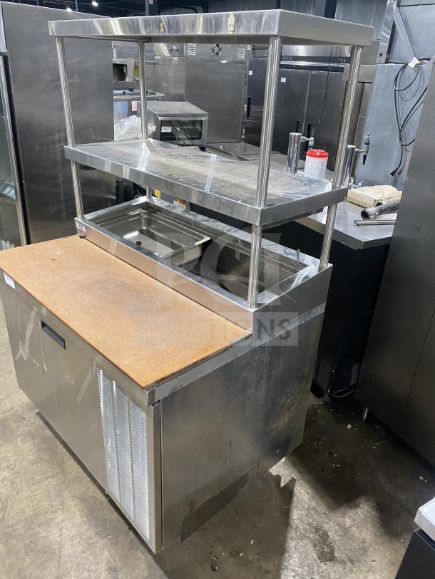 Delfield stainless steel 1-door refrigerated prep table with enclosed storage. Features mega top and overhead shelf. Good condition.