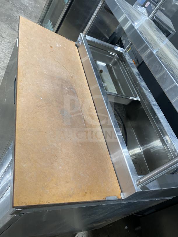 Delfield stainless steel refrigerated prep table, one door, mega top, enclosed storage, overhead shelf; good condition.