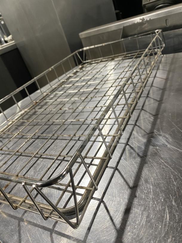 Stainless steel wire rack for commercial bagel display, excellent condition, durable and sleek design.