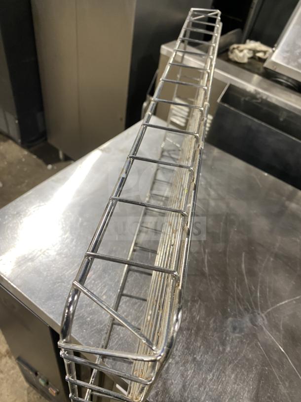 Commercial stainless steel bagel wrap holder, long rectangular design, grid pattern, excellent condition.