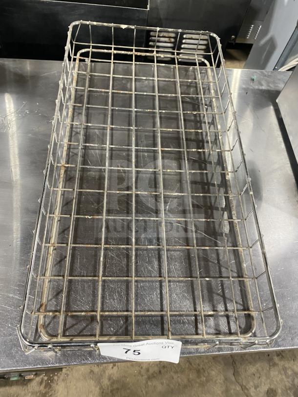Commercial stainless steel bagel wrap rack in used condition. Features durable grid design. Auction tag indicates item number 75.