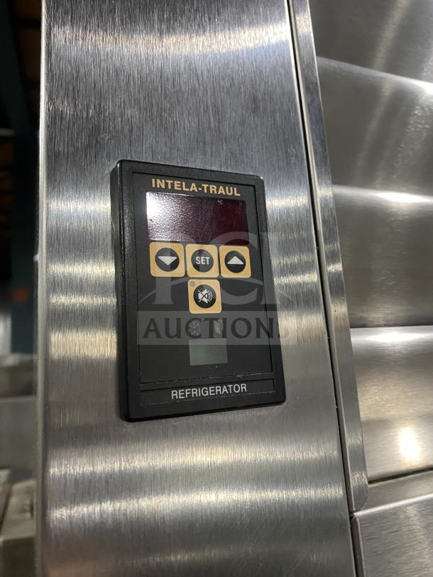 Traulsen RHT232WUT-HHS stainless steel refrigerator with digital control panel, split doors, pan racks, and sturdy legs.