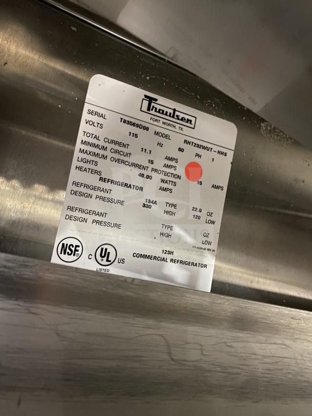 Traulsen RHT232WUT-HHS stainless steel refrigerator label, model and serial numbers visible. NSF and UL listed for safety.