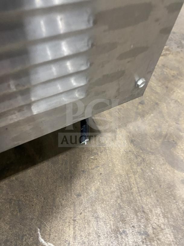 True TMCX34S stainless steel mobile milk cooler, single sided, electric-powered, showing minor wear, model detail visible.