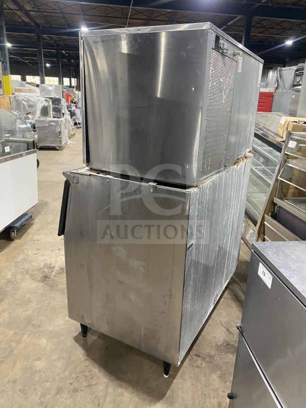 Hoshizaki KM-1301SAH3 commercial stainless steel ice maker, air-cooled, on legs, industrial setting, model visible.