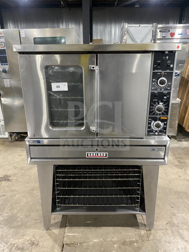 Garland Summit Series stainless steel convection oven, model TE4CH, with thermostatic controls, pan and wired oven rack, on legs.