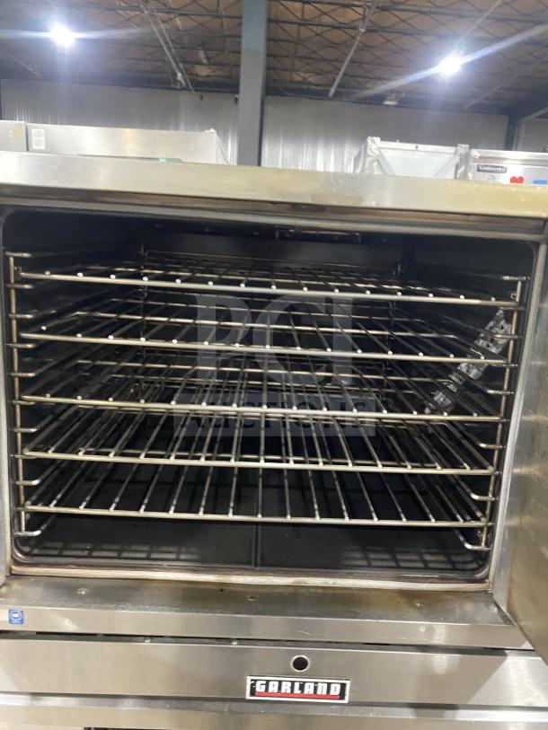 Garland Summit Series stainless steel convection oven, model TE4CH, with pan and wired racks, on legs, in good condition.