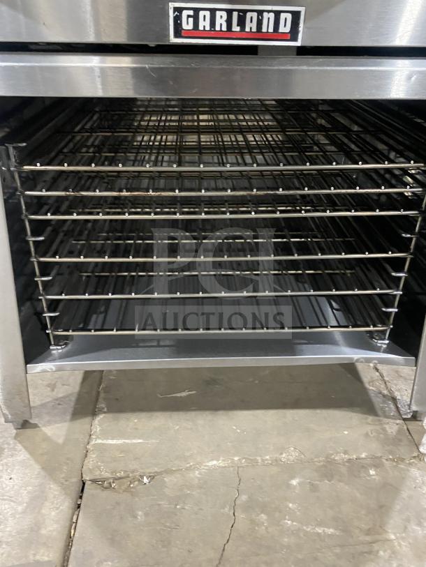 Garland TE4CH stainless steel convection oven, thermostatic controls, pan rack, wired rack, 208V, 1 Phase, on legs.