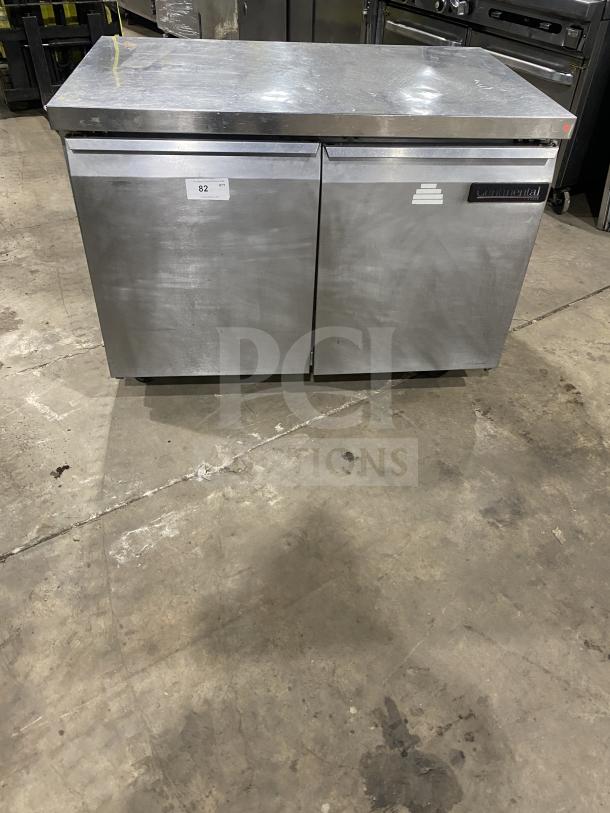 Continental stainless steel 2-door refrigerated prep table with poly-coated rack, casters, visible brand label, minor wear.