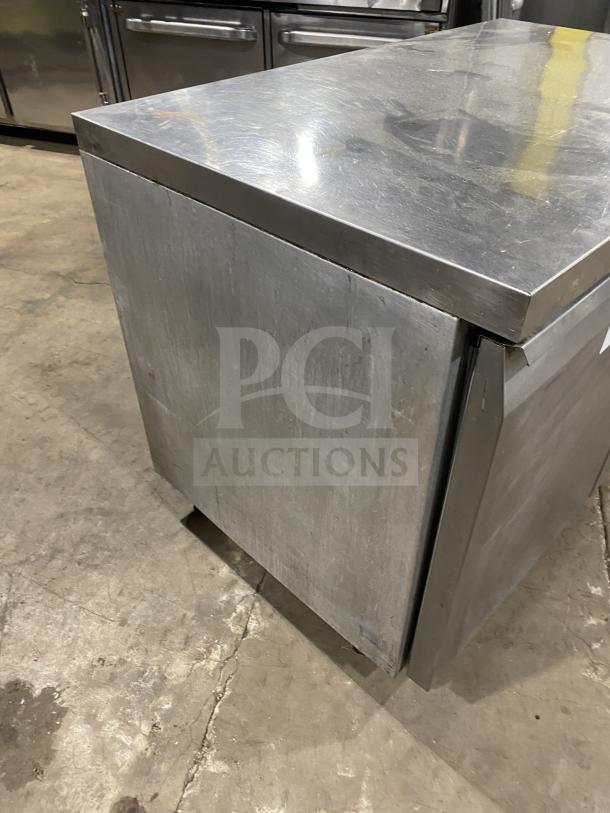 Continental stainless steel 2-door refrigerated prep table, includes poly-coated wired rack, on casters, good condition.