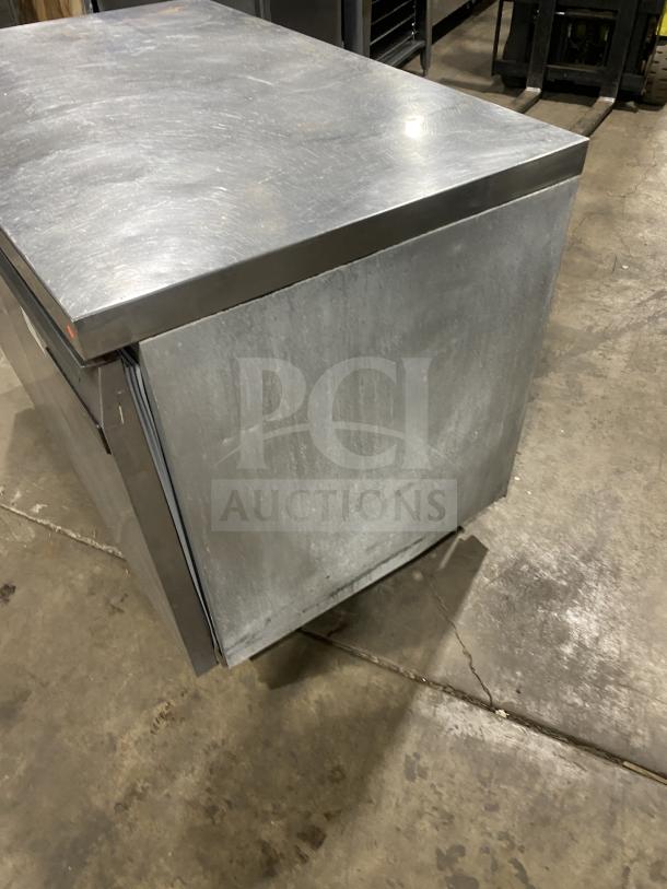 Continental stainless steel 2-door refrigerated prep table with poly-coated rack, on casters, used condition.