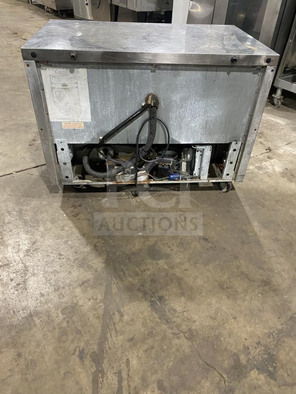 Continental stainless steel 2-door refrigerated prep table, with poly-coated wired rack, on casters, good condition.