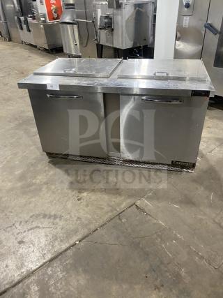 Continental SW601N24M stainless steel refrigerated salad prep table with two doors, poly coated rack, on casters.