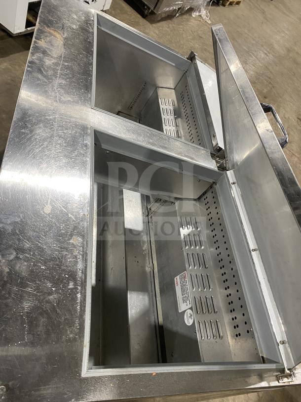 Continental SW601N24M stainless steel 2-door refrigerated prep table with poly-coated rack, on casters. Model tag visible.