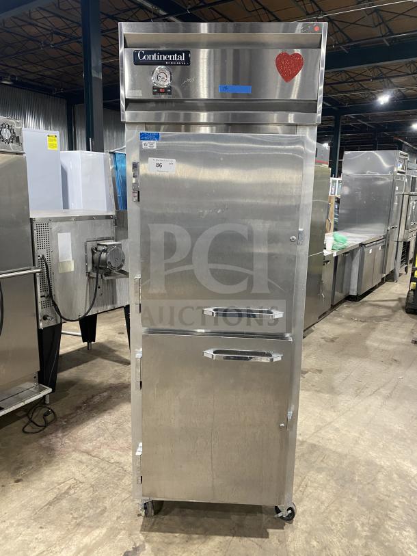 Commercial stainless steel 2-door Dutch style refrigerator by Continental, Model 1RE-HD. Features rack, shelf, on casters, 115V.