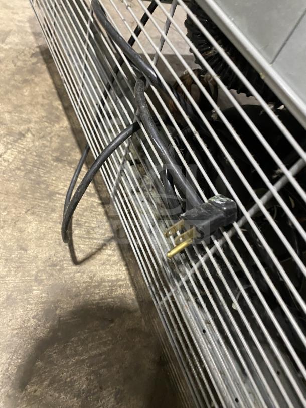 Asber ARF49HFHC commercial freezer back view, showing power cord and condenser, stainless steel finish, on casters.