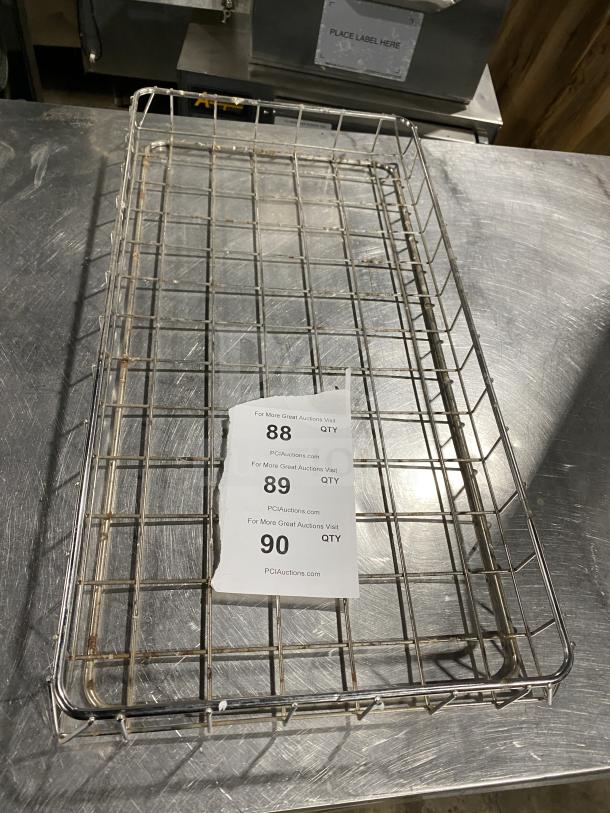 Stainless steel wire tray for bagel wraps, commercial grade. Some rust spots visible. Auction tags with lot numbers 88-90.