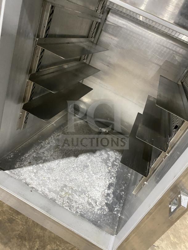 Continental 1RE-PT-HD two-door stainless steel refrigerator interior with racks and shelf visible; model and serial number present.