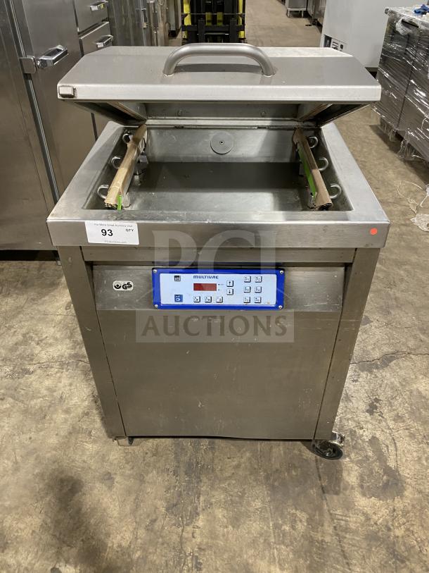 Multivac stainless steel chamber vacuum packing machine, open lid showing interior. Control panel with buttons. Good condition.