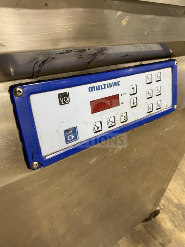 Multivac stainless steel chamber vacuum packing machine with digital display, control panel, and visible wear.