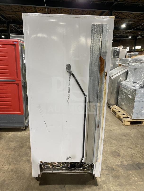 Arctic Air F22CW7 commercial freezer, stainless steel exterior with white body. Electric, on casters, visible wear on side.