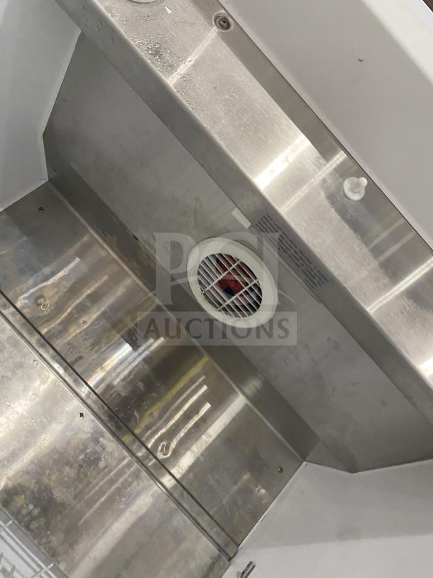 Arctic Air F22CW7 stainless steel reach-in freezer interior with fan vent, showing clean condition. Model SN: WB91910324.