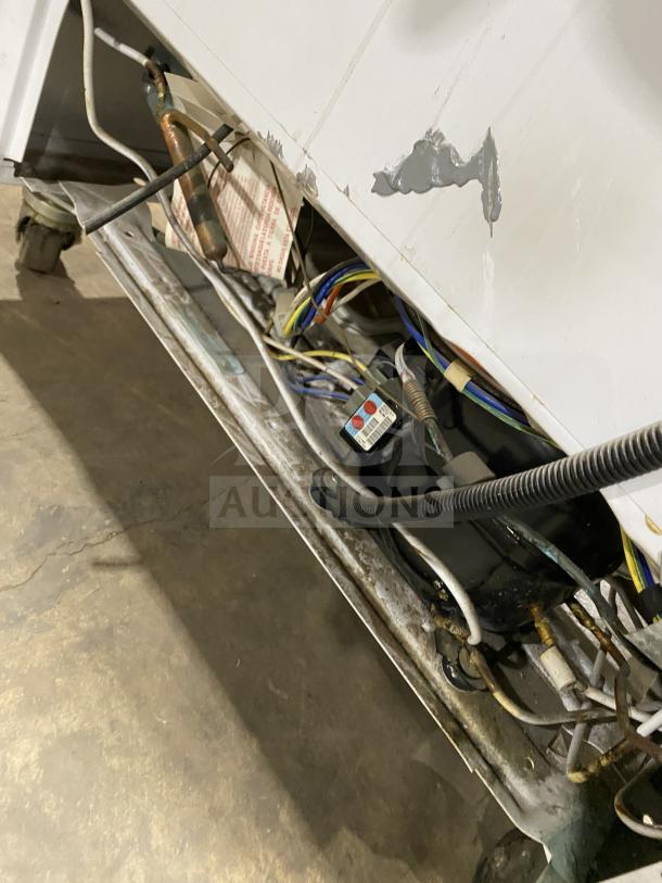 Arctic Air F22CW7 freezer on casters, white stainless steel, visible wear, electrical components, Model SN: WB91910324, 115V.