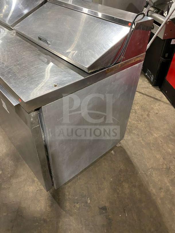 Continental 3-door stainless steel refrigerated prep table, Model SW72-18, with poly coated rack, on casters, good condition.