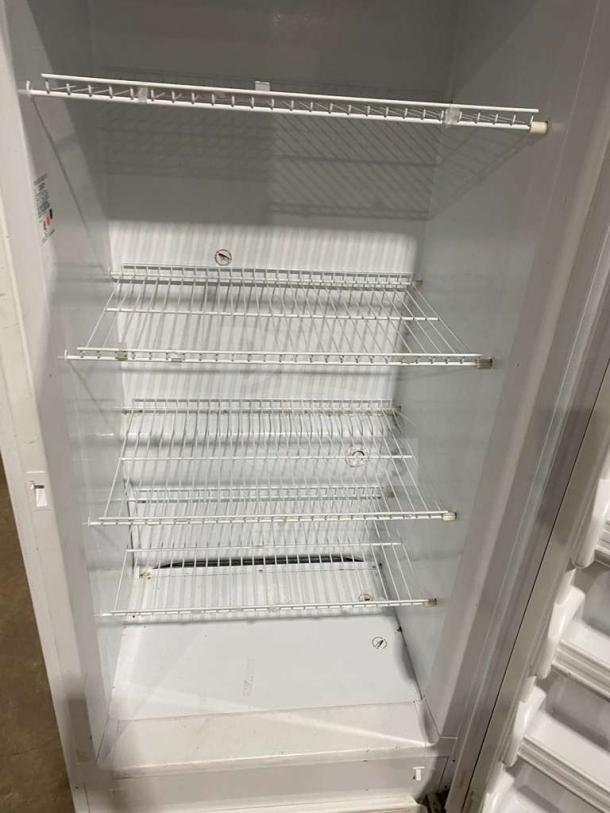 Frigidaire white single door reach-in freezer, model FFUH21F2NWA, with poly-coated wired racks, Energy Star certified.