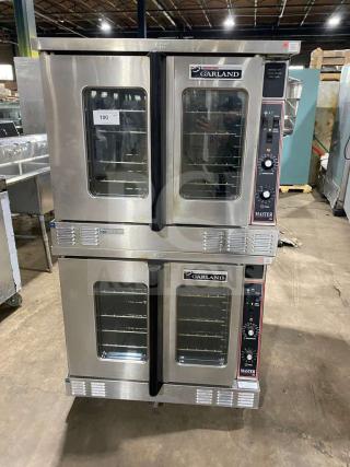 Garland stainless steel double-stacked gas convection oven with thermostatic controls, wired racks, and on casters.