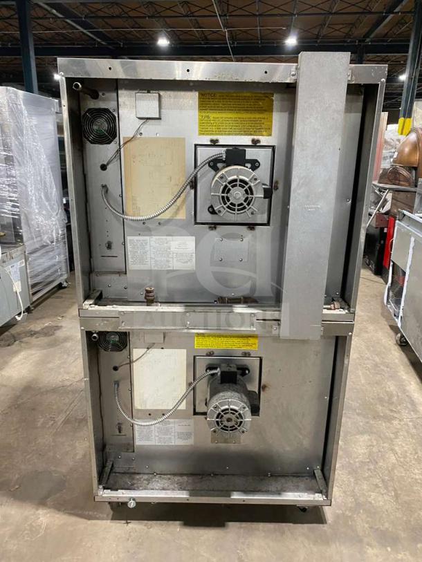 Garland commercial stainless steel double stacked convection oven with wired rack, thermostatic controls, and casters.