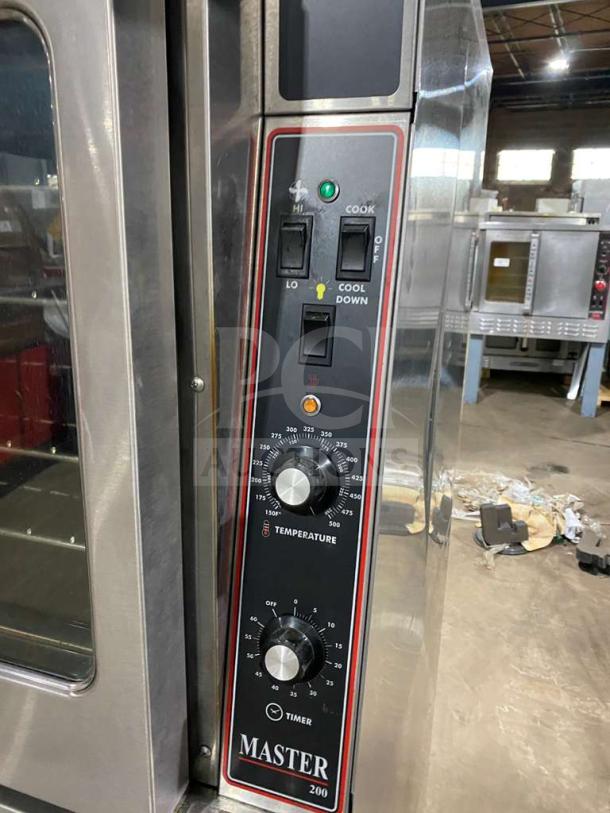 Garland stainless steel double stacked convection oven with thermostatic controls and wired rack, on casters.