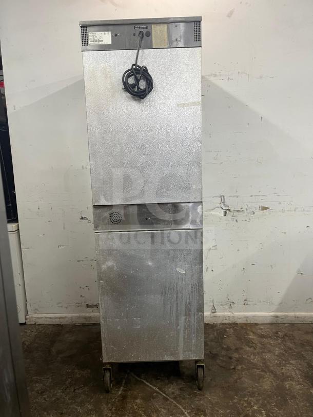 Alto-Shaam 1000-UP Holding Cabinet, 120V, stainless steel, used condition, visible cord, label showing model information.