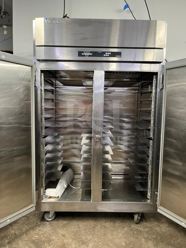 Victory UltraSpec high roll-thru refrigerator with solid front and rear doors, spacious interior, stainless steel, excellent condition.
