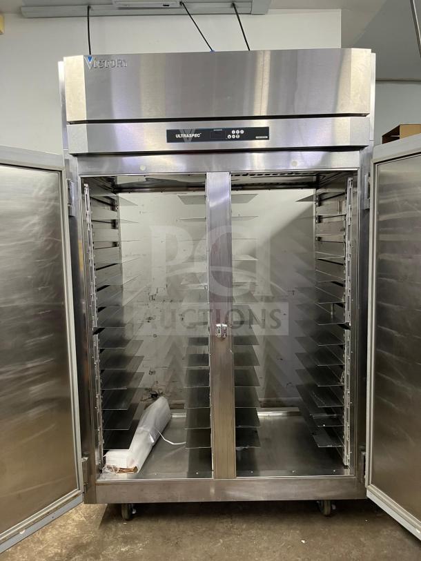 Victory UltraSpec roll-thru refrigerator, clean stainless steel design, dual solid doors open, model branding visible.