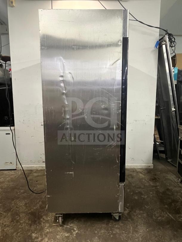 North American Precision Series A2GDF double glass door merchandiser freezer, fair condition, with visible dents and scratches.