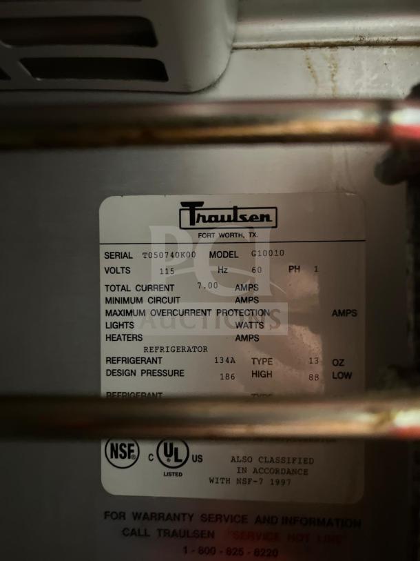 Traulsen G10010 refrigerator label showing model, serial number T050740K00, 115 volts, 134A refrigerant, UL listed.